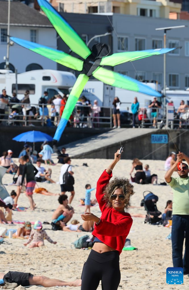 A woman flies a kite during Australia's annual kite festival, the Festival of the Winds, at Bondi Beach in Sydney, Australia, Sept. 13, 2026. (Xinhua/Gong Bing)
