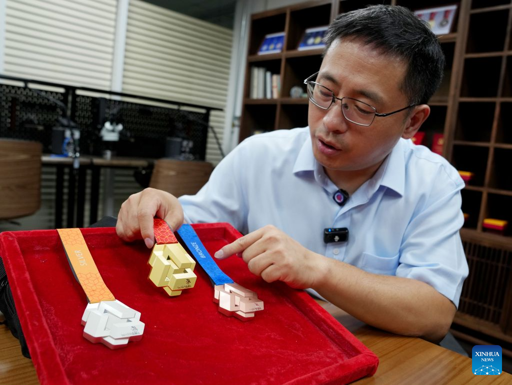 Li Wenjun, an engineer of Shanghai Mint Co., Ltd., introduces the manufacturing process of the medals of the 48th WorldSkills Competition in east China's Shanghai, Sept. 8, 2026. Shanghai Mint Co., Ltd. has officially shipped all the medals for the 48th WorldSkills Competition recently, which will be awarded at the competition scheduled to take place in Shanghai from Sept. 22 to 27. (Xinhua/Liu Ying)