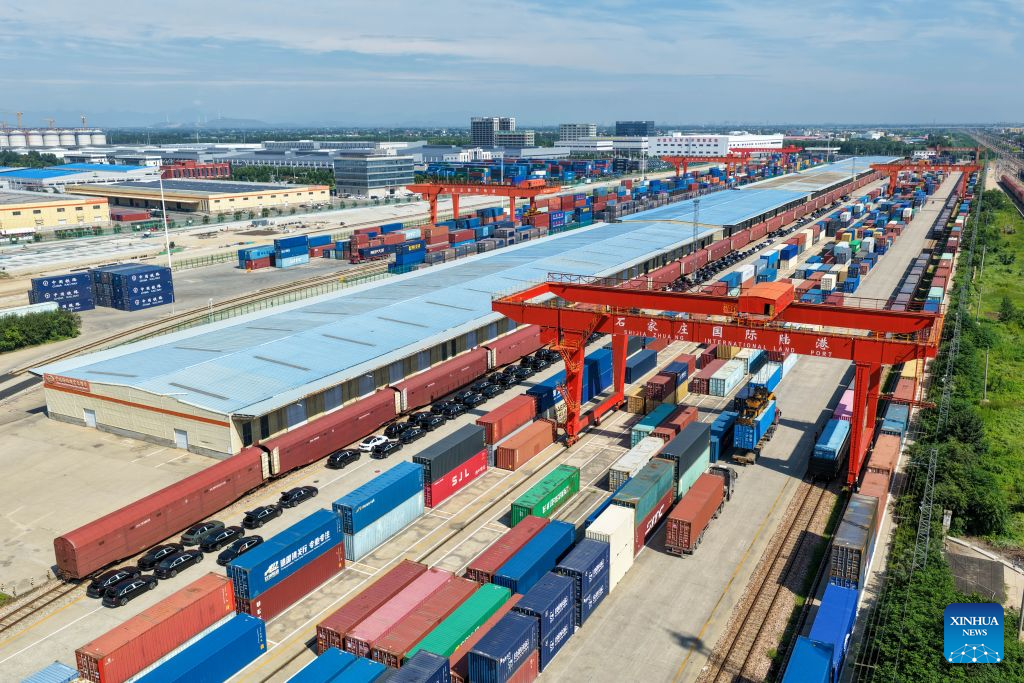 This aerial drone photo taken on Aug. 4, 2026 shows a container loading site of the Shijiazhuang international land port in north China's Hebei Province. Shijiazhuang international land port in north China's Hebei Province handled a total of 814 China-Europe and China-Central Asia freight train trips in the first half of 2026, up 42.06 percent year on year. (Photo by Liang Zidong/Xinhua)