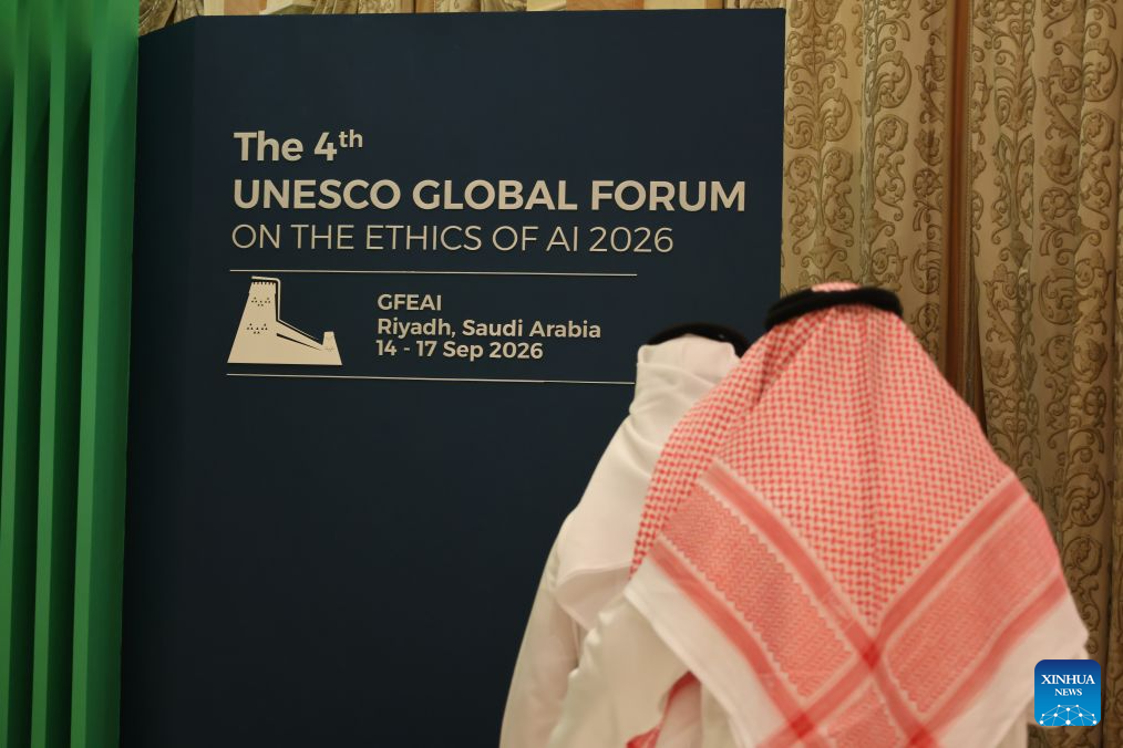 Participants walk past a display board during the 4th Global Forum on the Ethics of Artificial Intelligence in Riyadh, Saudi Arabia, Sept. 15, 2026. The 4th Global Forum on the Ethics of Artificial Intelligence (AI) opened in Riyadh on Tuesday, where delegates discussed aligning AI development with safety and responsibility requirements. (Xinhua/Luo Chen)