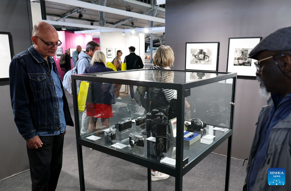 People visit an exhibition on the history of cameras and photography at the Salon Photo & Video in Paris, France, Oct. 8, 2026. The Salon Photo & Video opened in Paris on Thursday, featuring equipment displays, photography exhibitions, talks and hands-on activities. (Xinhua/Wu Huiwo)