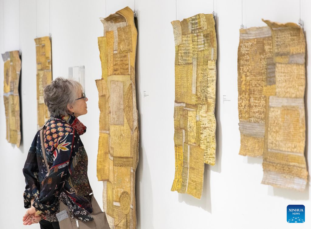 A visitor views artworks on display at the World of Threads Festival 2026 in Oakville, Ontario, Canada, on Sept. 28, 2026. Showcasing contemporary fibre and textile art in all forms from around the world, the event will last till Jan. 17, 2027. (Photo by Zou Zheng/Xinhua)