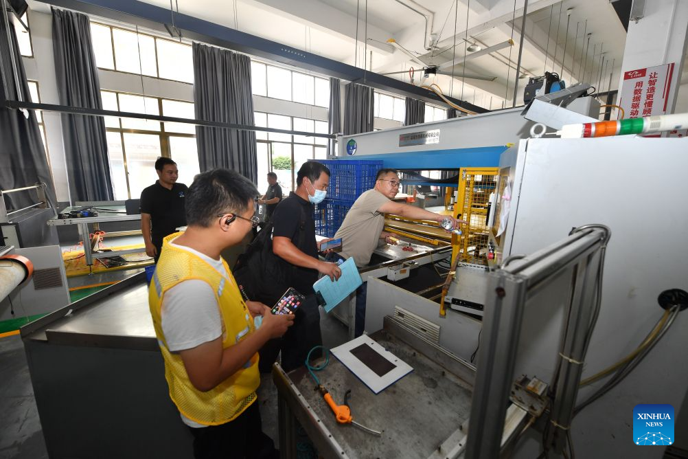 Staff members check the condition of a shoemaking machine at a factory at the Hualin economic development zone in Putian, southeast China's Fujian Province, Sept. 7, 2026. As heavy rainfall caused by Typhoon Saudel in Putian concluded on Saturday, floodwaters gradually receded in inundated areas of this city. Local authorities have since shifted to post-disaster recovery, undertaking tasks including water and power restoration, sanitation and disinfection, as well as the resettlement of affected residents. (Xinhua/Jiang Kehong)