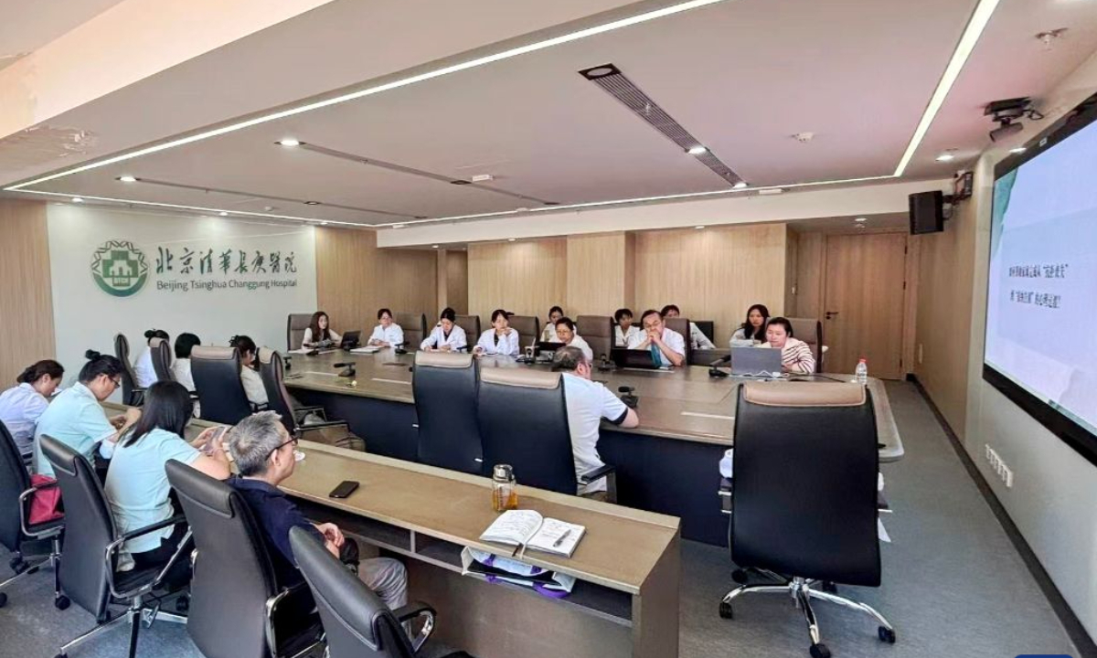 Lu Guijun and his hospice team carry out the hospice care grand rounds at a conference room of Beijing Tsinghua Changgung Hospital in Beijing, China, Sept. 21, 2026. (Xinhua)