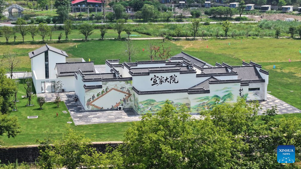 A drone photo taken on June 28, 2026 shows a view inside a Xuan paper cultural town in Jingxian County, east China's Anhui Province. Xuan paper is a delicate, long-lasting type of paper traditionally used for Chinese calligraphy and painting. It originated in Jingxian County, which was under the jurisdiction of Xuanzhou during the Tang Dynasty (618-907) -- and that was also how the paper got its name. The paper is traditionally made from straw and bark of a special tree found only in China.
In recent years, Jingxian County has mingled Xuan paper culture into tourism and cultural creativity. In addition to viewing conventional exhibitions, visitors are now encouraged to get a hands-on experience with Xuan paper-making craft by closely observing the complete production process and trying their hands at certain steps. An array of cultural and creative products and local souvenirs is also available to visitors.
Jingxian County has received 3.2 million visitors since late June this year, up 84.6 percent year on year, garnering tourism revenue of 1.657 billion yuan (about 245.5 million U.S. dollars) during the period, an increase of 38.3 percent year on year. (Photo by Nie Fang/Xinhua)