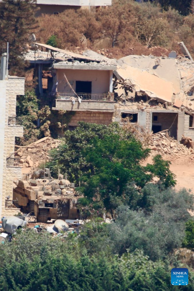 This photo taken on Aug. 3, 2026 shows an Israeli military vehicle stationed in Zawtar al-Sharqiyah, southern Lebanon. The Lebanese army said on July 26 that continued Israeli attacks and violations of existing understandings are obstructing its deployment in southern Lebanon and delaying the return of residents to their border villages. (Photo by Ali Hashisho/Xinhua)