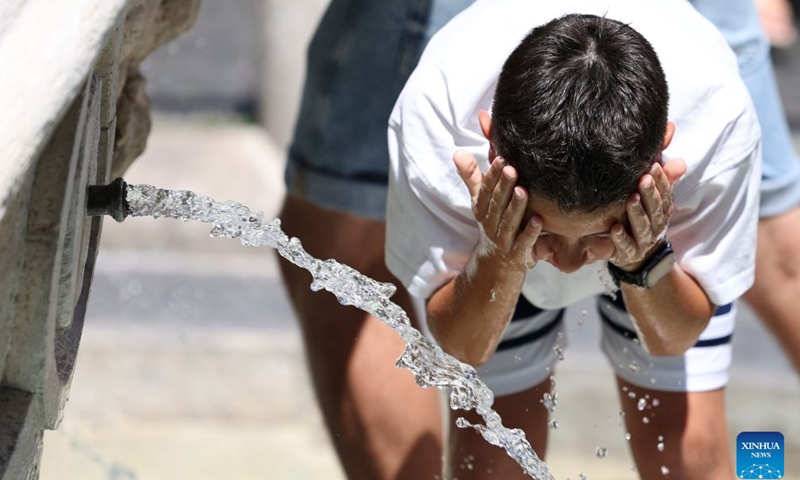 A boy cools off at Fontana della Barcaccia amid a heatwave in Rome, Italy, June 21, 2026. (Xinhua/Li Jing)

