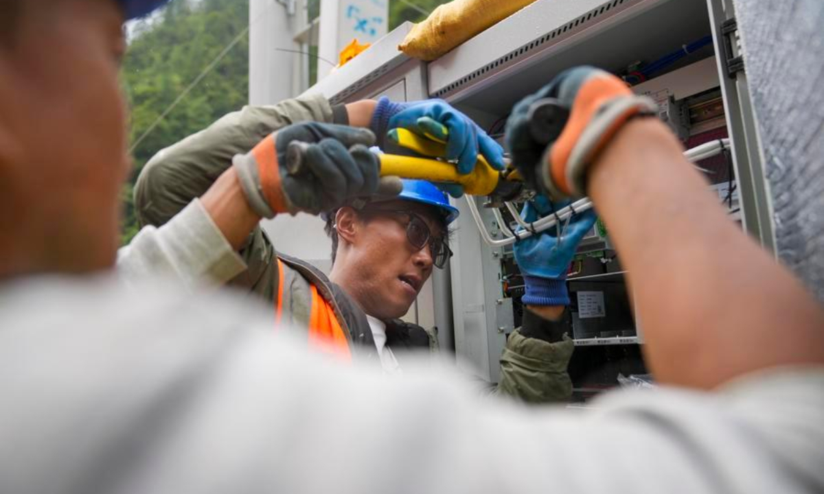 Staff members work on a signal base station in Gyirong Town, southwest China's Xizang Autonomous Region, Aug. 29, 2026.  (Xinhua/Jigme Dorje)