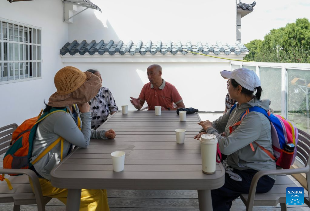 Fan Qiang (3rd L), a sojourner from southwest China's Sichuan Province, shares his sojourn experience with several tourists visiting for summer retreat at his rented sojourn residence in Lyuyintang Natural Village of Xunlong Village in Sayu Town, Zhaoyang District, Zhaotong City, southwest China's Yunnan Province, Aug. 13, 2026. In recent years, Zhaoyang District in Zhaotong City has leveraged its cool and pleasant climate to boost the in-depth sojourn tourism experience as a summer retreat.

The local government has introduced special support policies for summer retreat tourism, optimizing services including dining, lodging, transportation, sightseeing, shopping, and entertainment. (Xinhua/Chen Xinbo)