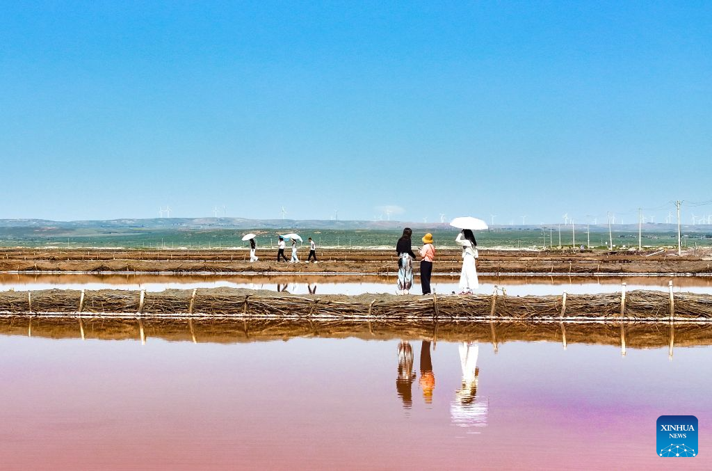 A drone photo taken on Aug. 5, 2026 shows tourists having fun at a salt lake in Otog Front Banner in the city of Ordos, north China's Inner Mongolia Autonomous Region. (Photo by Wang Zheng/Xinhua)