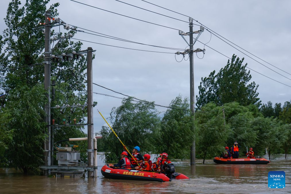 Rescue workers inspect power facilities for potential hazards in Nanwang Village of Xiangzhou District, Xiangyang City of central China's Hubei Province, Aug. 12, 2026. Torrential rains and flooding caused by Typhoon Dolphin, the 13th typhoon of the year, have swept vast regions in eastern and central China. Local authorities are exerting all efforts to eradicate potential risks and put people's life back to normal. (Xinhua/Wu Zhizun)