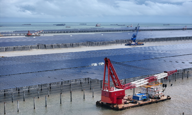 Workers carry out offshore operations at the CNNC Tianwan tidal flat photovoltaic (PV) demonstration project in Lianyungang, East China's Jiangsu Province, on August 23, 2026. Jiangsu became the first province to exceed 100 million kilowatts of solar power installations, with PV overtaking coal, gas and wind to become the province's largest power source. Photo: VCG