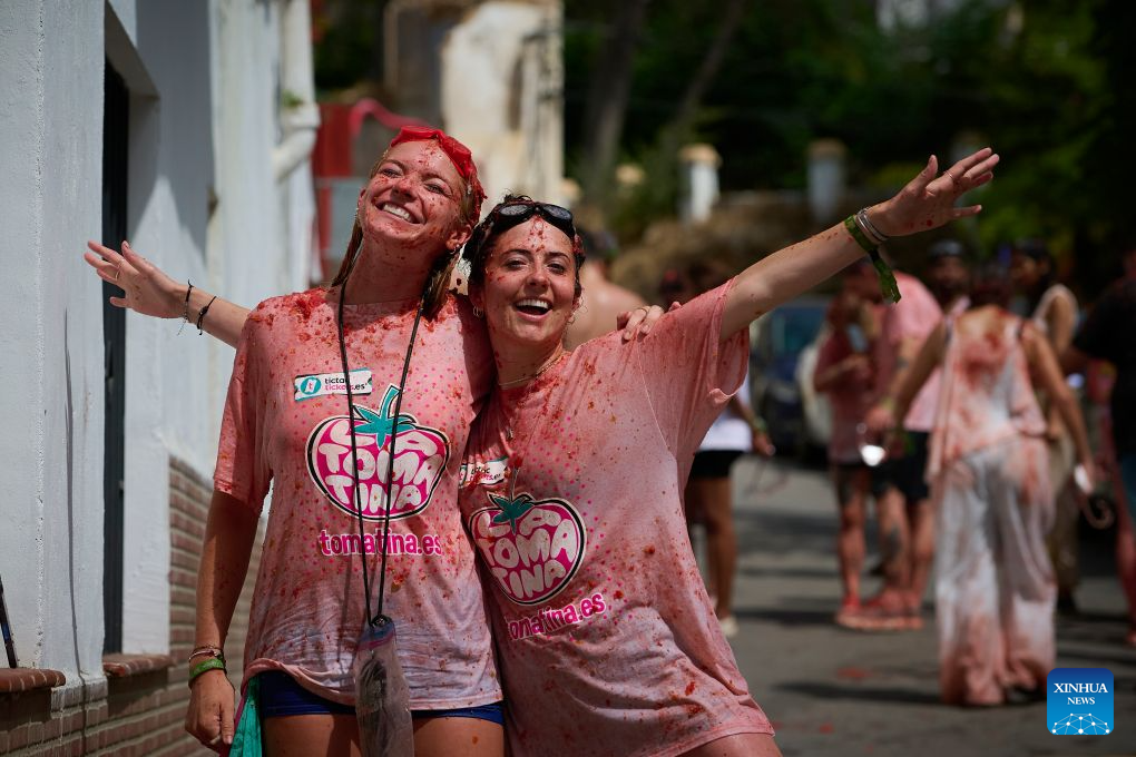 Revellers are pictured during the annual tomato fight (La Tomatina) in Bunol near Valencia, Spain, Aug. 26, 2026. (Photo by Pablo Morano/Xinhua)