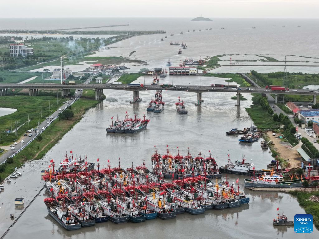 An aerial drone photo taken on Aug. 12, 2026 shows fishing boats preparing to depart for the Yellow Sea after a fishing ban was lifted in Lianyungang City, east China's Jiangsu Province. Special licensed fishing vessels set out to the Yellow Sea as the summer fishing moratorium was partially lifted on Aug. 12, which had been postponed for a week due to impacts of Typhoon Dolphin. (Photo by Si Wei/Xinhua)
