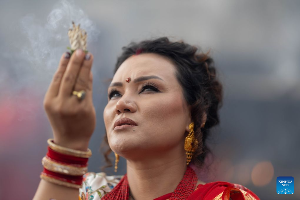 A woman offers prayers at the Pashupatinath Temple during the Teej Festival in Kathmandu, Nepal, Sept. 14, 2026. Hindu women observe the festival by fasting, praying and celebrating, seeking marital well-being and ideal partners. (Photo by Sulav Shrestha/Xinhua)