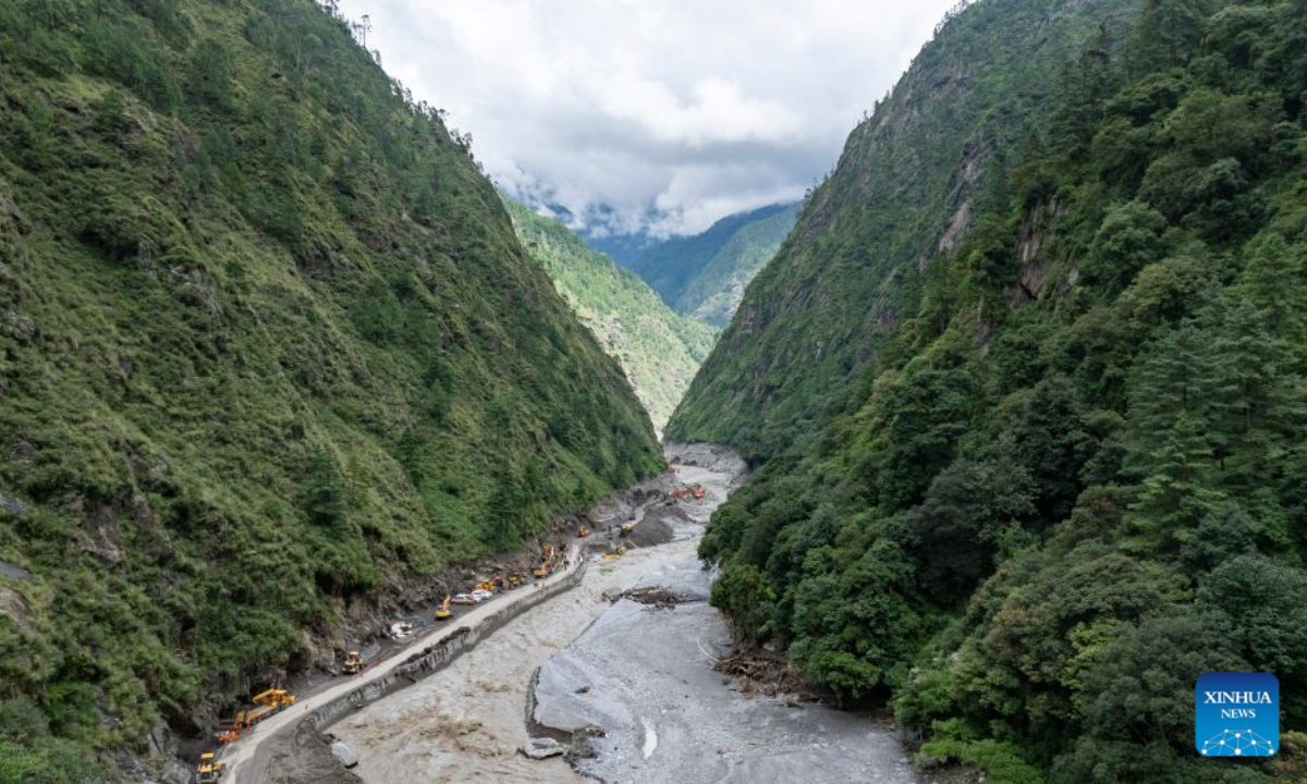 An aerial drone photo shows a road clearance operation underway in a section of the G216 national highway from Gyirong Town to Gyirong Port in southwest China's Xizang Autonomous Region, on Aug. 30, 2026. China Anneng, a state-owned engineering and rescue enterprise, continued its rescue work on Sunday in an attempt to restore the last few kilometers of damaged section of the G216 national highway leading to Gyirong Port. (Xinhua/Jigme Dorje)