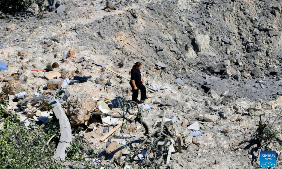 Photo taken on Aug. 6, 2026, shows a resident standing beside a large crater at the site of a house destroyed in an Israeli airstrike before dawn in Burj al-Shemali, near the southern Lebanese city of Tyre. Four people were injured early Thursday in Israeli airstrikes targeting the town of Burj al-Shemali, near the southern city of Tyre, according to Lebanon's state-run National News Agency. (Photo by Ali Hashisho/Xinhua)