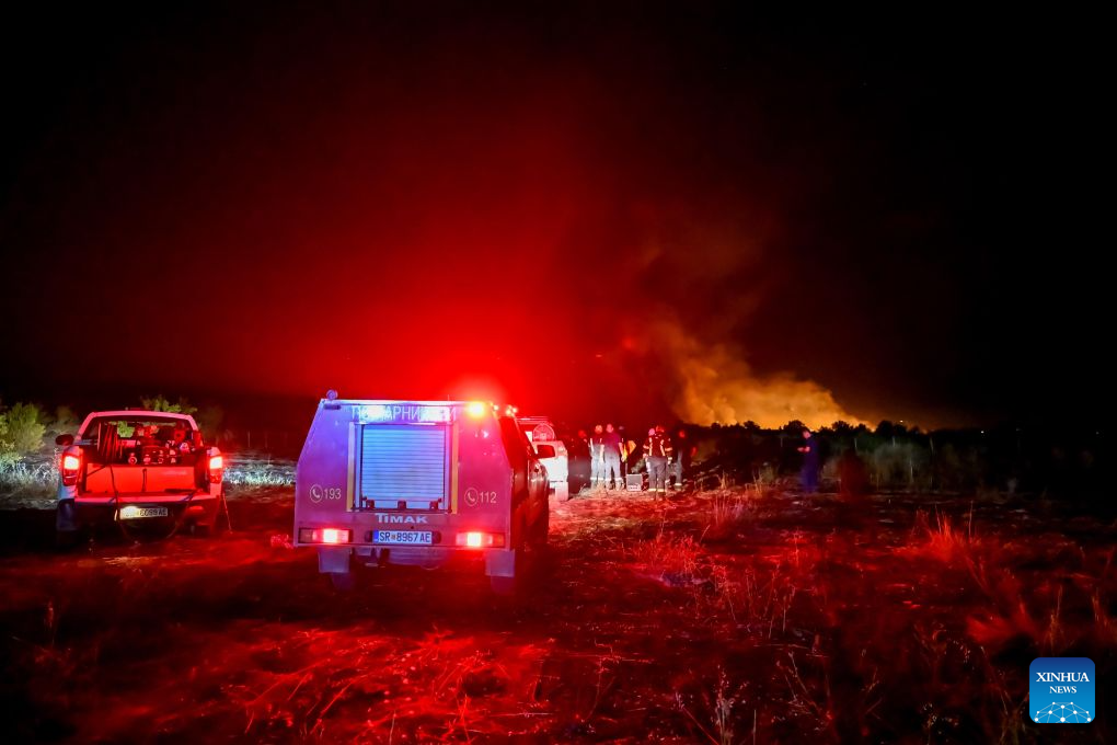 Firefighters are seen in an operation to control a spreading wildfire fueled by weeks of extreme summer heat and dry vegetation in Strumica, North Macedonia, Aug. 22, 2026. (Photo by Tomislav Georgiev/Xinhua)