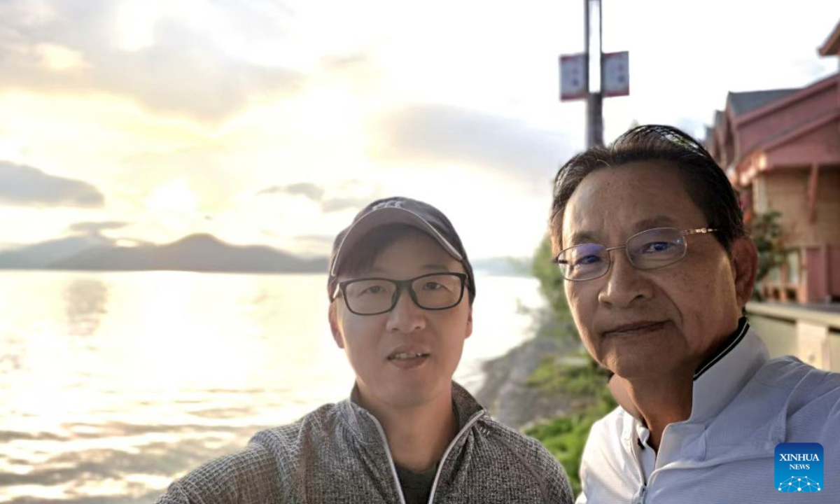 Chen Jie (L) and Fei Hai-ping take a selfie at the Lugu Lake in southwest China's Yunnan Province, July 9, 2026. (Xinhua)