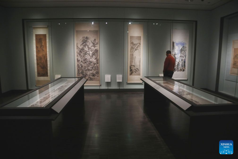 A visitor views an exhibit at an exhibition named The Mountains of the Mind: A Chinese Landscape Journey at the Asian Art Museum in San Francisco, the United States, Sept. 19, 2026. The exhibition, featuring over 20 paintings, runs from December 13, 2025 to October 26, 2026. (Photo by Liu Yilin/Xinhua)