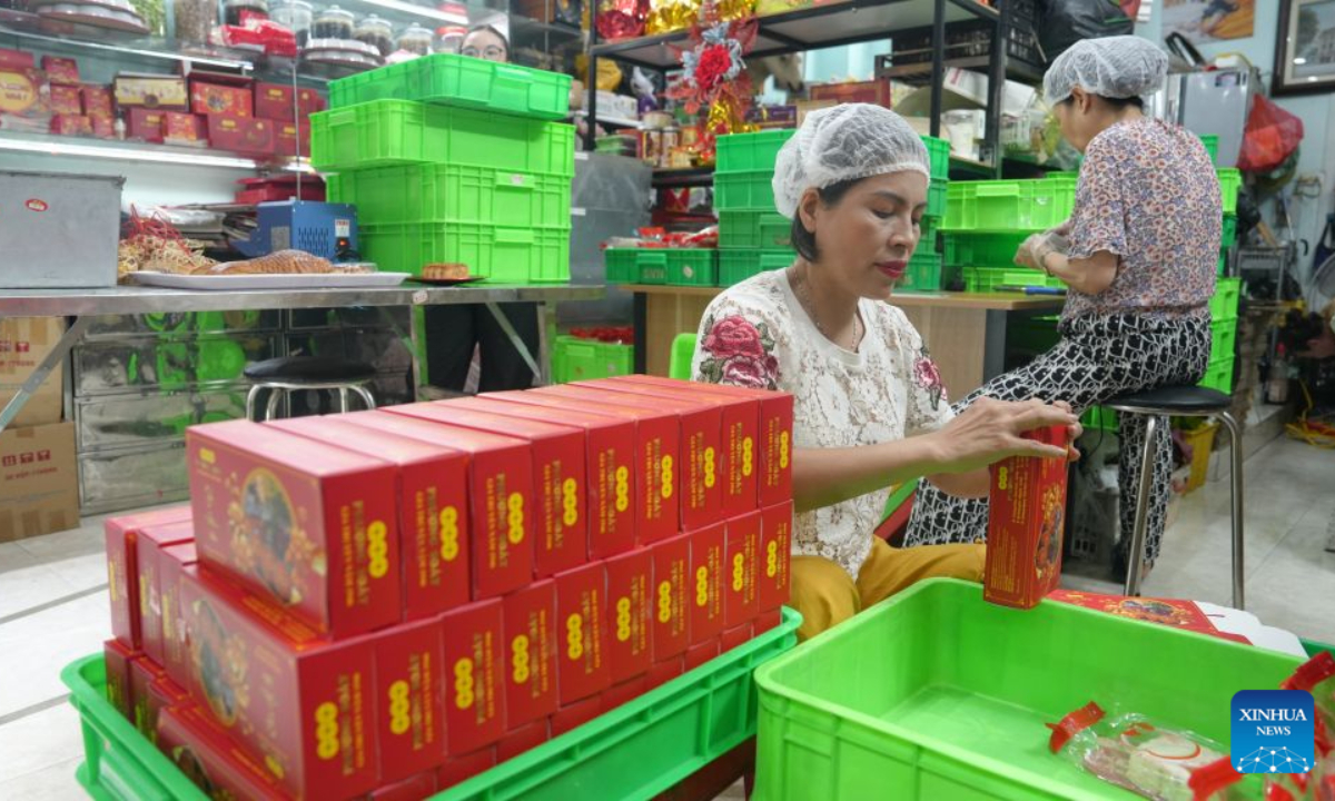 Workers pack mooncakes at a traditional confectionery shop in Hanoi, Vietnam, Sept. 17, 2026. A festive atmosphere is growing here as the Mid-Autumn Festival approaches. (Xinhua/Hu Jiali)