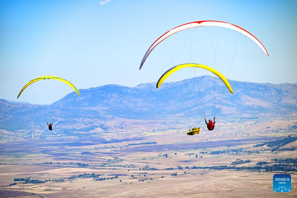 Participants compete during the 18th World Air Sports Federation (FAI) European Paragliding Championships in Krushevo, North Macedonia, Aug.16, 2026. The event is taking place from Aug. 8 to 19, bringing together 130 of Europe's top pilots. (Photo by Tomislav Georgiev/Xinhua)