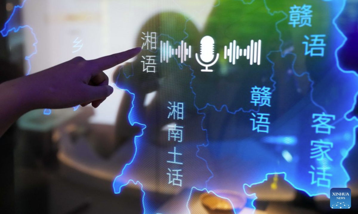 A visitor listens to dialects of various regions in Hunan at the Exhibition Hall of the Project for the Protection of Language Resources of China in Changsha, central China's Hunan Province, Aug. 24, 2026. A new exhibition hall dedicated to the preservation of China's diverse language resources opened on Monday in Changsha, capital of central China's Hunan Province, bringing a decade-long effort to document languages and dialects to the public through digital and interactive displays. The Exhibition Hall of the Project for the Protection of Language Resources of China, located in the Hunan Museum, brings together recordings and other language materials collected from more than 1,800 field survey sites across China, covering Chinese dialects, ethnic minority languages and related cultural traditions. (Xinhua/Xue Yuge)