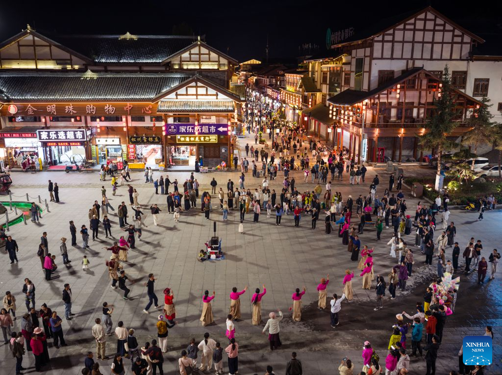 People enjoy Guozhuang dance at Songzhou Ancient City in Songpan County of Aba Tibetan and Qiang Autonomous Prefecture, southwest China's Sichuan Province, Aug. 23, 2026. Songzhou Ancient City in Songpan County is now a major historical and cultural site protected at the national level. (Photo by Lan Hongguang/Xinhua)