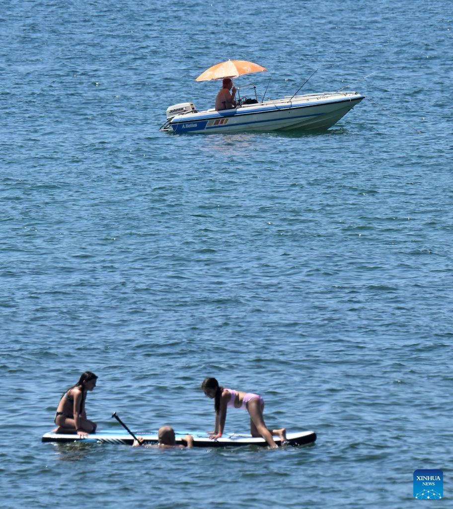 People cool off in the sea in Ladispoli, Italy, June 21, 2026. (Photo by Alberto Lingria/Xinhua)