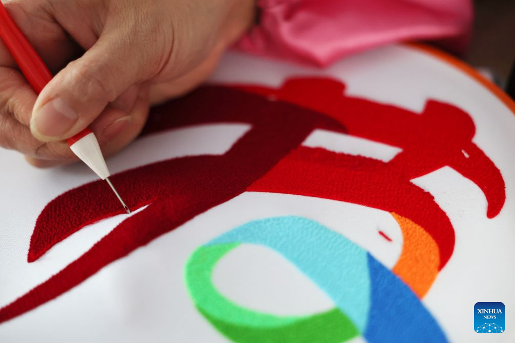 A worker makes Duoxiu embroidery works at a workshop in Yuanzhou District, Guyuan City of northwest China's Ningxia Hui Autonomous Region, Sept. 21, 2026. Yuanzhou District in Guyuan City has developed an integrated model combining intangible cultural heritage, original design and e-commerce, encouraging local businesses to develop original Duoxiu embroidery patterns and expand handicraft markets. The district has established 12 community handicraft workshops, creating jobs for more than 3,600 people and turning traditional skills into economic opportunities. (Xinhua/Liu Yun)