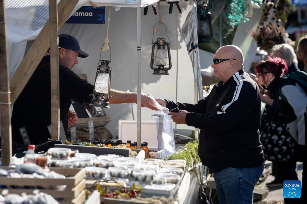 Visitors shop at stalls during the Helsinki Baltic Herring Market at Market Square in Helsinki, capital of Finland, Oct. 7, 2026. The Helsinki Baltic Herring Market is held in Helsinki, the capital of Finland. In 2026, it runs from October 4 to 10. Dating back to 1743, it is one of Finland's oldest public events, aimed at supporting fishermen's livelihoods and promoting local seafood, particularly Baltic herring. (Photo by Matti Matikainen/Xinhua)