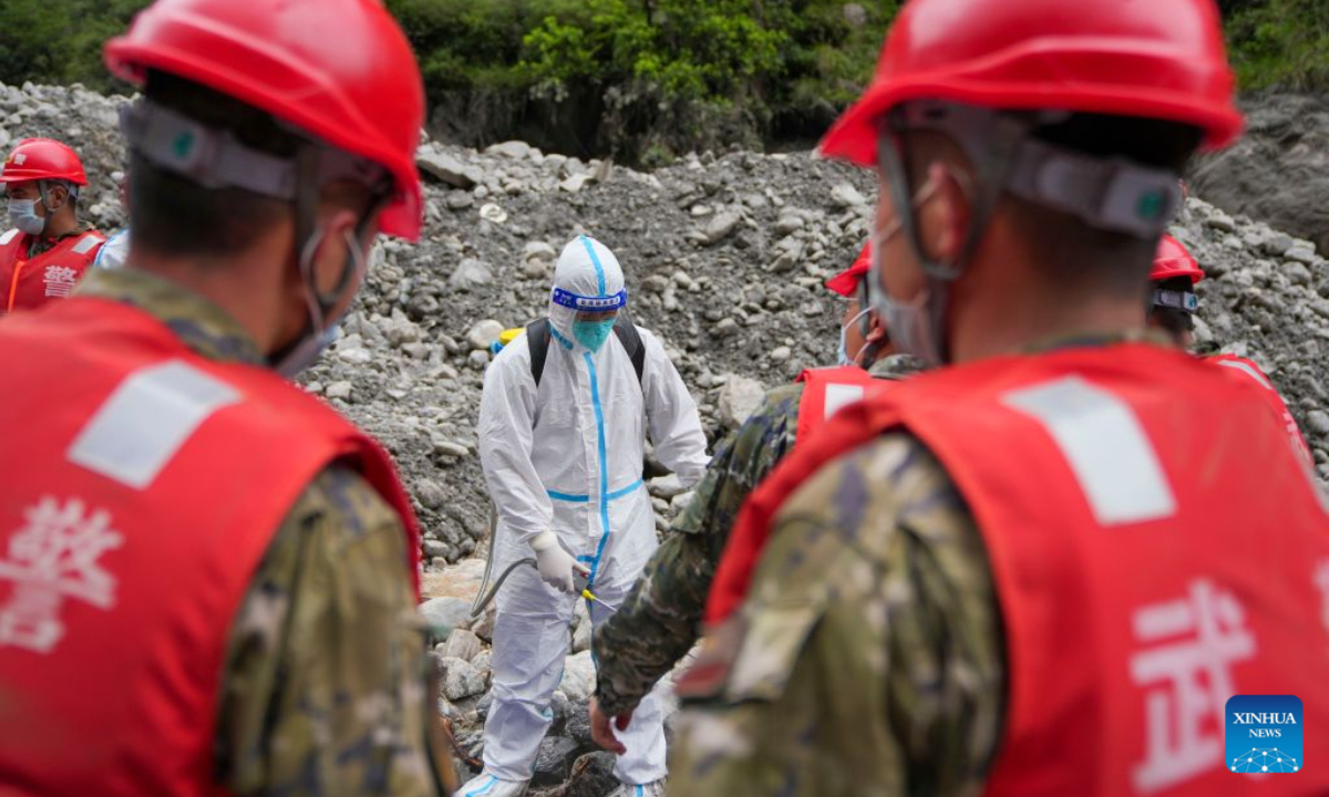 A worker conducts disinfection for rescuers at the mudslide-hit area in Gyirong County, southwest China's Xizang Autonomous Region, Aug. 30, 2026. Disinfection operations were carried out after a devastating mudslide, triggered by an ice-rock avalanche in Nepal, hit the border port of Gyirong in southwest China's Xizang Autonomous Region. (Xinhua/Jigme Dorje)