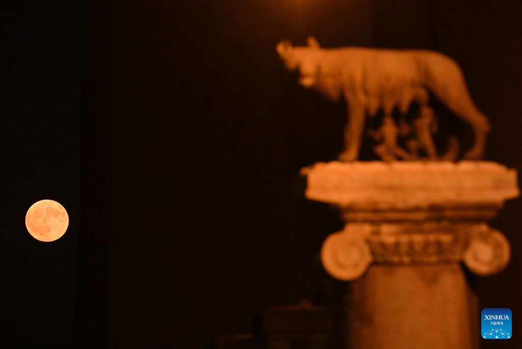This photo taken on July 29, 2026 shows a full moon and the She-Wolf with Romulus and Remus statue in Rome, Italy. (Photo by Alberto Lingria/Xinhua)