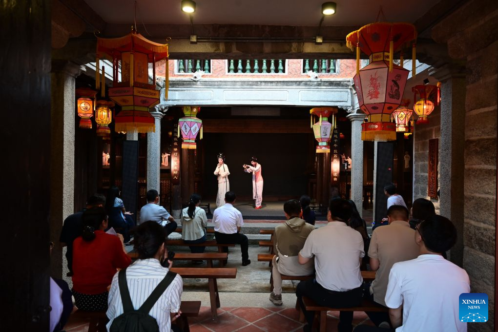 Tourists watch a local opera performance at a theater on the Qiaonan ancient street in Quanzhou City, southeast China's Fujian Province, Aug. 18, 2026. Qiaonan ancient street in Quanzhou is a historical and cultural block which still preserves traditional Minnan buildings and overseas-Chinese mansions. Minnan literally means southern Fujian Province. In recent years, local government has promoted the protection and utility of this block by rolling out innovative management mode. (Xinhua/Lin Shanchuan)