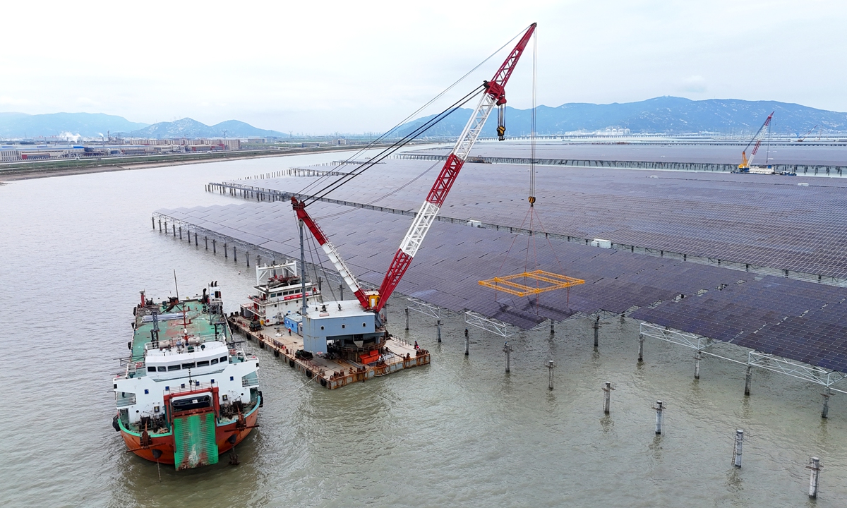 The construction site of CNNC Tianwan's 2-million-kilowatt tidal flat PV demonstration project in Lianyungang, East China's Jiangsu Province, bustles with activity on June 22, 2026. As of mid-June, the project's cumulative installed capacity of PV modules had exceeded 1 million kilowatts, meaning that more than half of the installation work had been completed. Photo: VCG