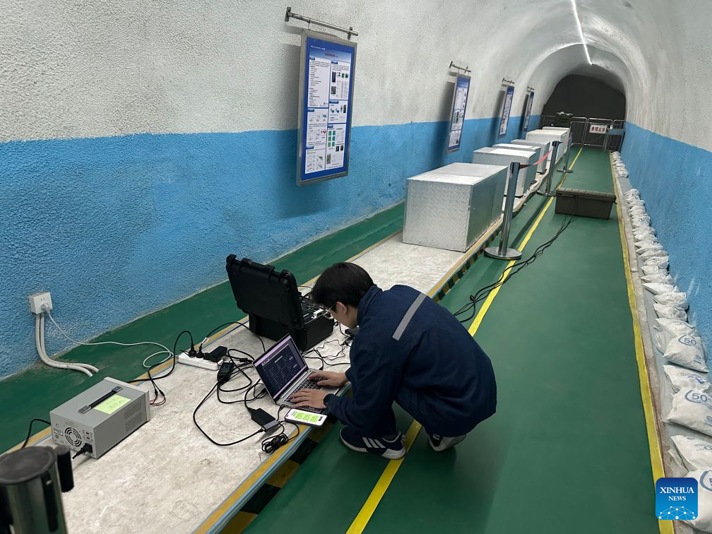 Zhou Yuanrui, a doctoral student at Jilin University, debugs an unshielded SERF atomic magnetometer at a deep earth laboratory in Taishan, east China's Shandong Province, April 24, 2025. (Xinhua)