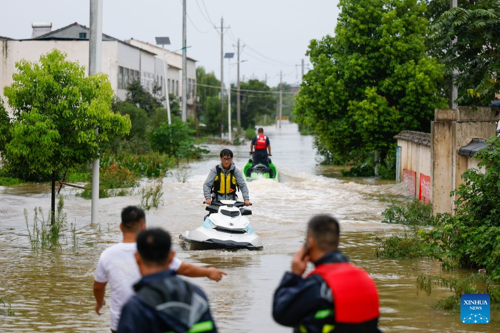 Rescue workers conduct operations using motorized boats in Nanwang Village of Xiangzhou District, Xiangyang City of central China's Hubei Province, Aug. 12, 2026. Torrential rains and flooding caused by Typhoon Dolphin, the 13th typhoon of the year, have swept vast regions in eastern and central China. Local authorities are exerting all efforts to eradicate potential risks and put people's life back to normal. (Xinhua/Wu Zhizun)