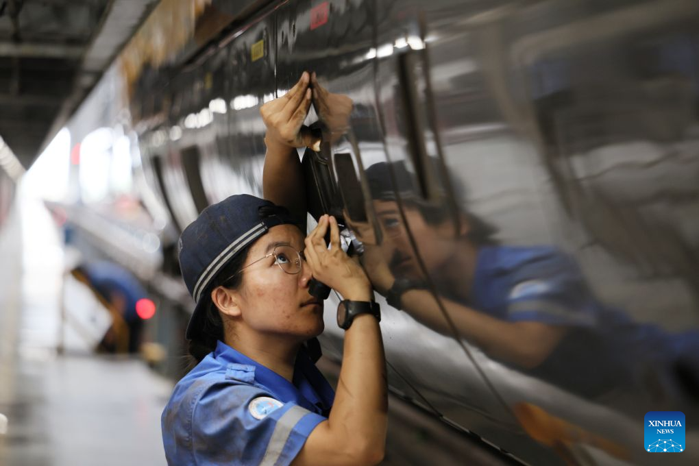 Li Weijia works at the maintenance base of an electric multiple unit (EMU) depot in Tianjin, north China, July 31, 2026. (Xinhua/Li Ran)