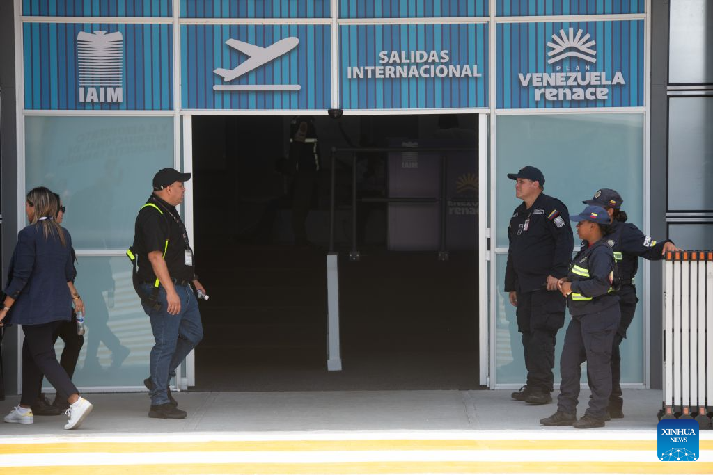 Airport personnel and members of the Bolivarian National Police are seen at a gate of a temporary terminal of the Maiquetia International Airport, in Maiquetia, La Guaira state, Venezuela, on Sept. 1, 2026. Maiquetia International Airport, Venezuela's main airport serving Caracas, formally resumed commercial operations Tuesday at temporary terminals built after its original infrastructure was damaged by the June 24 earthquakes. (Photo by Marcos Salgado/Xinhua)