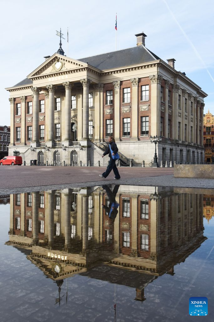 A woman walks by the city hall of Groningen, the Netherlands, Sept. 14, 2026. Groningen, the capital of the Dutch province of Groningen, is a historic city in the north of the Netherlands. (Xinhua/Shao Haijun)