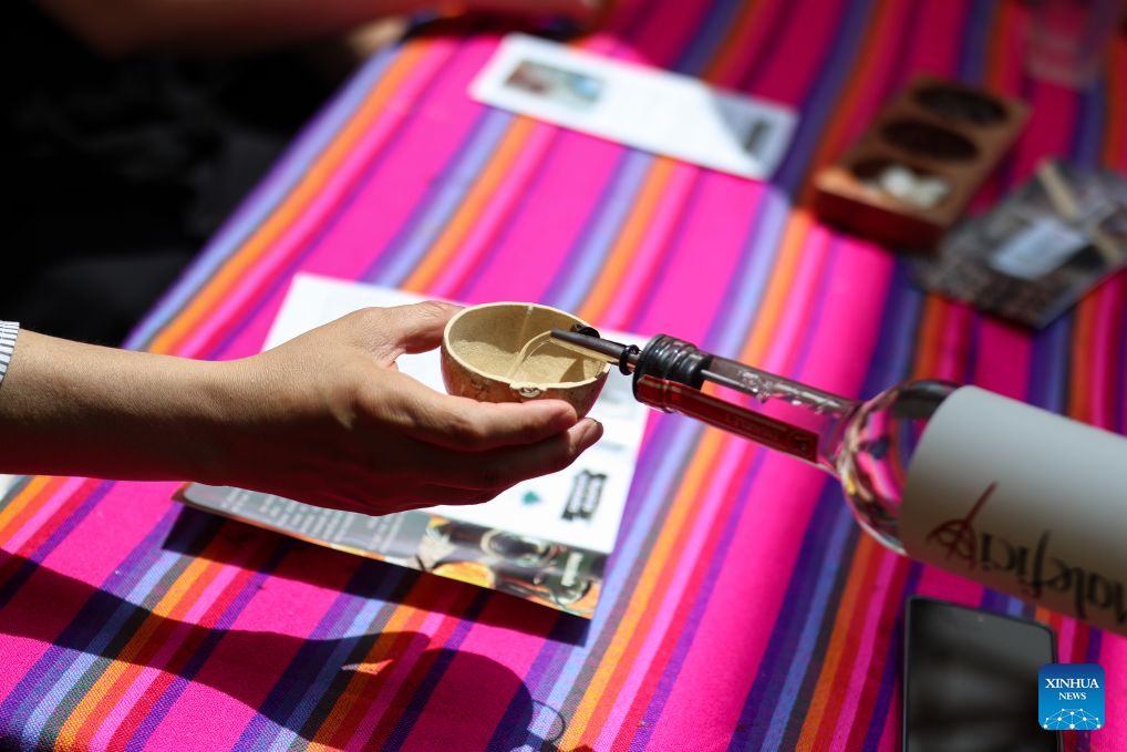 A staff member pours mezcal, an alcoholic beverage made from the agave plant, for a visitor during the Pulque, Traditional Cuisine and Mezcal Festival in Mexico City, capital of Mexico, Sept. 5, 2026. The event, featuring more than 100 varieties and expressions of agave-based beverages, as well as tastings, food pairings and other activities, was held in Mexico City on Saturday. (Photo by Francisco Canedo/Xinhua)