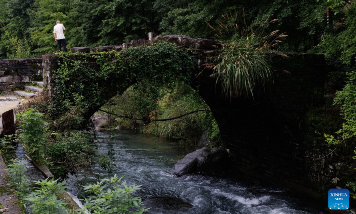 This photo taken on July 6, 2026 shows a bridge in Shi Ting Village, Yixian County, east China's Anhui Province. The ancient village of Shi Ting, located in the north of Yixian County in east China's Anhui Province, boasts of beautiful natural scenery and profound cultural heritage. (Xinhua/Jin Liwang)