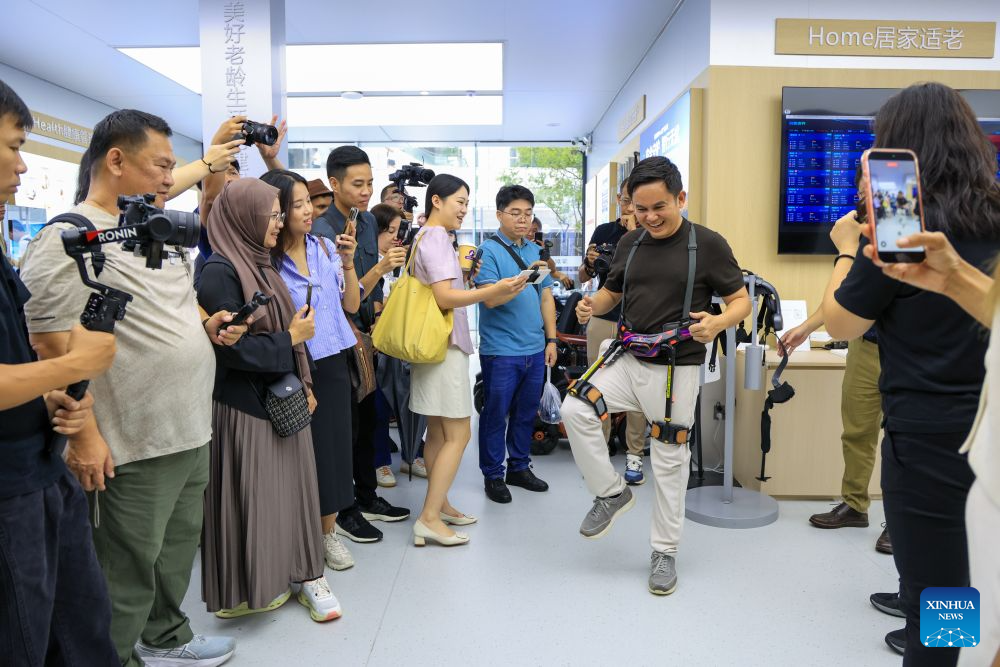A content creator from Myanmar tries an exoskeleton robot at a robotics zone in Shenzhen, south China's Guangdong Province, July 29, 2026. Over 20 journalists and social media influencers from ASEAN countries visited Shenzhen on Wednesday.
This year marks the fifth anniversary of the establishment of the China-ASEAN Comprehensive Strategic Partnership. (Xinhua/Mao Siqian)