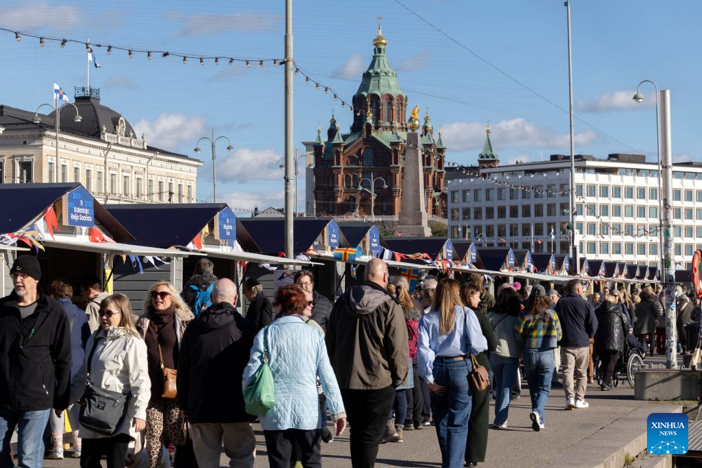 Crowds of visitors browse stalls at the Helsinki Baltic Herring Market at Market Square in Helsinki, capital of Finland, Oct. 7, 2026. The Helsinki Baltic Herring Market is held in Helsinki, the capital of Finland. In 2026, it runs from October 4 to 10. Dating back to 1743, it is one of Finland's oldest public events, aimed at supporting fishermen's livelihoods and promoting local seafood, particularly Baltic herring. (Photo by Matti Matikainen/Xinhua)