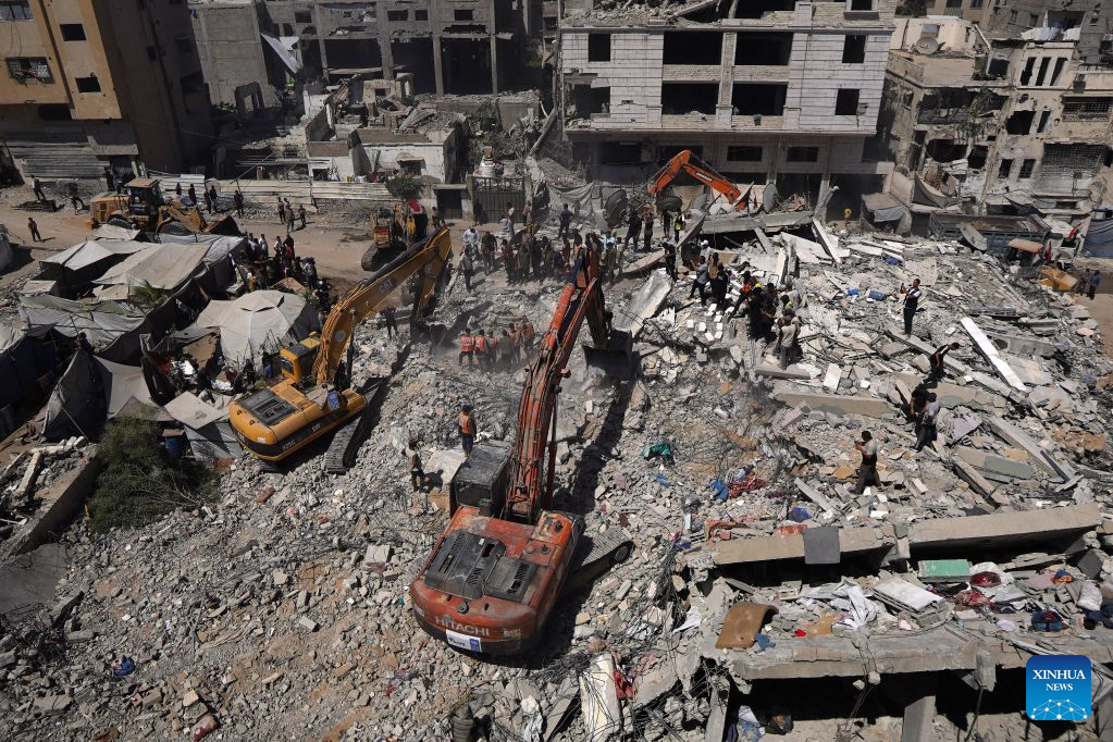 Palestinian civil defense crews search for bodies and survivors in the rubble of a collapsed building that housed displaced Palestinians in Gaza City, Sept. 16, 2026. The death toll from the collapse of a residential building in western Gaza City rose to 21, including 11 children and six women, with more than 25 injured, local officials and residents said Wednesday. (Photo by Rizek Abdeljawad/Xinhua)