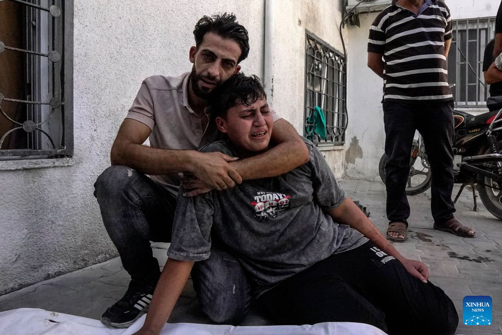 Palestinians mourn over victims who were killed by an Israeli airstrike, at Al-Shifa hospital, in Gaza City, on Aug. 19, 2026. At least nine Palestinians, including a woman, were killed Wednesday in an Israeli airstrike targeting a Hamas-run municipal police headquarters in central Gaza City, according to Palestinian sources.
Sources and witnesses said the airstrike caused a large explosion and scattered shrapnel around the headquarters, which is surrounded by tents housing displaced people. (Photo by Rizek Abdeljawad/Xinhua)