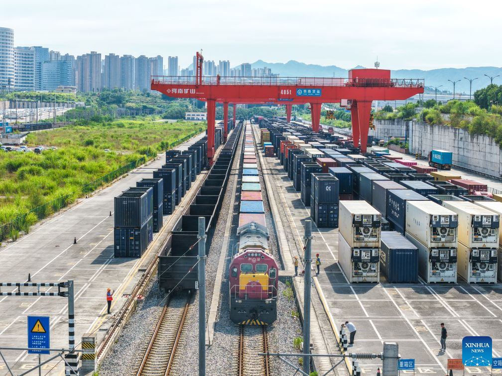 An aerial drone photo taken on July 30, 2026 shows a freight train of the New International Land-Sea Trade Corridor waiting for departure at Yuzui Station in Chongqing, southwest China. A total of 961 rail freight train trips were operated from Chongqing via the New International Land-Sea Trade Corridor in the first half of the year, up 25.6 percent year on year, according to the logistics division of China Railway Chengdu Group Co., Ltd.
Chongqing's imports and exports via the corridor amounted to 28.71 billion yuan (about 4.25 billion U.S. dollars) during the same period, rising 13.7 percent year on year, according to data from Chongqing Customs. (Xinhua/Tang Yi)