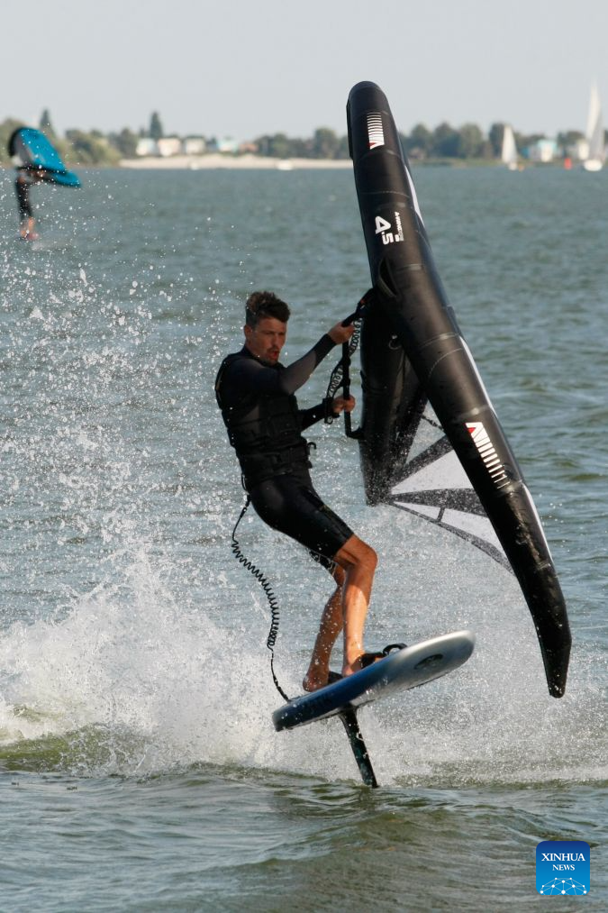 A surfing enthusiast surfs on the Ijsselmeer lake near Kornwerderzand in Friesland Province, the Netherlands, Aug. 2, 2026. (Xinhua/Shao Haijun)
