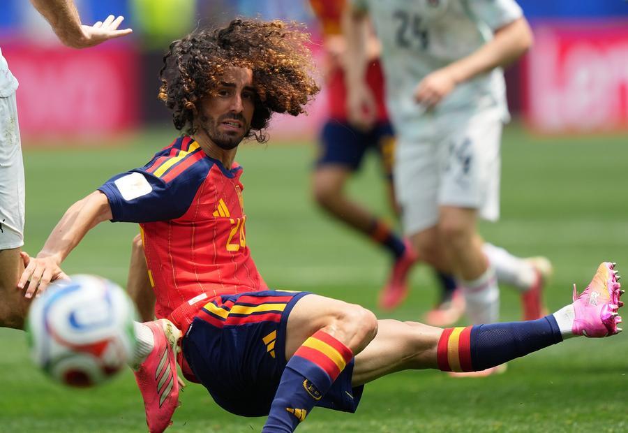 Spain's Marc Cucurella goes for a tackle during the match. (Xinhua/Chen Yichen)