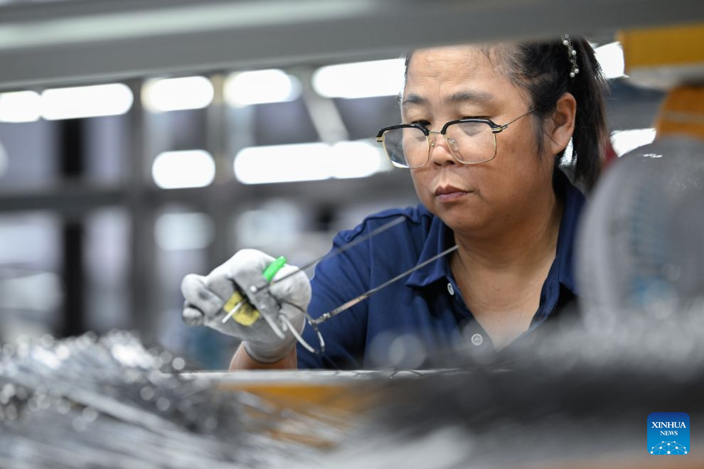 A staff member conducts quality check on a pair of eyeglasses at a workshop in Fengjie County, southwest China's Chongqing Municipality, Sept. 15, 2026. In recent years, Fengjie County has vigorously developed its eyewear industry, which provided over 3,500 new jobs, with products exported to more than 30 countries and regions. (Xinhua/Chen Cheng)